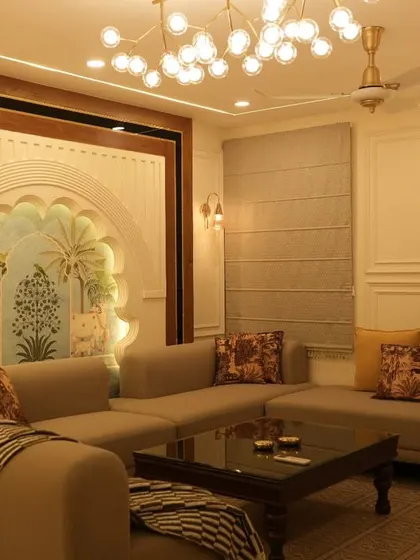 A full view of a living room that blends modern furniture with traditional Indian architectural elements, such as the arched wall niche and patterned floor tiles. The warm lighting creates an inviting and comfortable atmosphere.