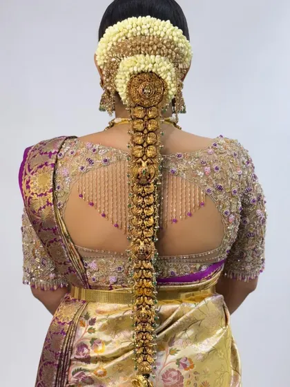 A close-up of the stunning back design of this bridal blouse. The intricate beadwork and unique cut create a look of modern elegance.