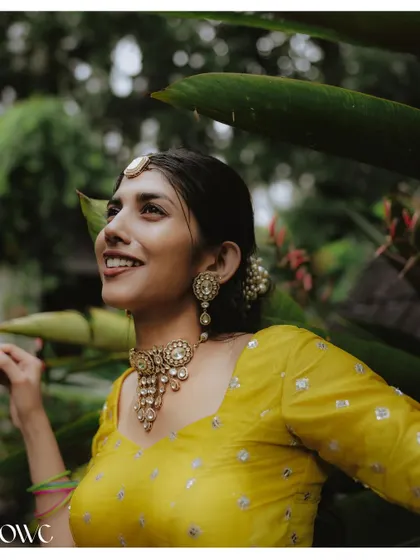 A candid and happy portrait of the bride during her outdoor Haldi photoshoot.