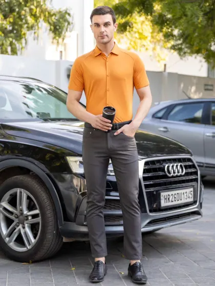 A male model wearing a Harfunlife performance shirt in a natural, outdoor lifestyle setting. This type of e-commerce photography shows apparel in a real-world context, helping customers visualize themselves wearing the product.