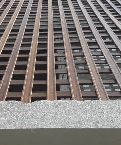 A detailed look at a facade created with our eco-friendly Tipwood. This grid-like design offers partial screening and creates beautiful light and shadow patterns, showcasing the material's versatility.