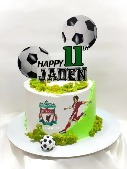 A simple yet effective football theme cake for a Liverpool fan. The design features the team's logo and a player in action, making it a great choice for any sports lover.