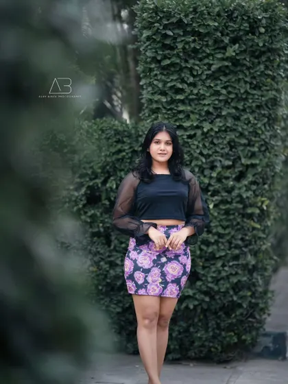 A full-length version of the outdoor fashion shoot. This shows the complete outfit and pose, giving a better sense of the overall style.