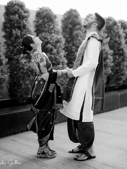 A moment of shared, unrestrained laughter between the couple, captured in black and white.