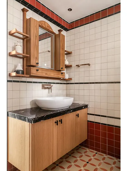The vanity in the Kolam Pop bathroom, with its black granite top, wooden cabinetry, and a custom mirror that reflects the project's blend of tradition and modernity.