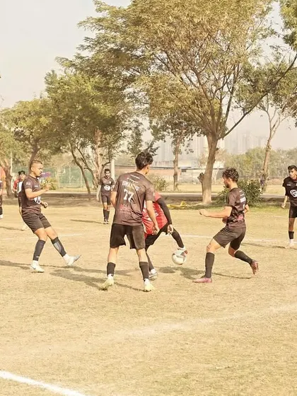 Players battling for possession in the midfield. This image captures the high-pressure, competitive nature of our league games.