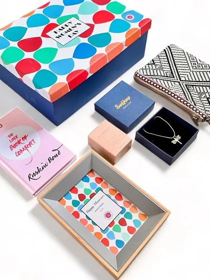 Our Women's Day gift sets are designed to feel like a warm hug. This one includes a book by Ruskin Bond, a beautiful clutch, jewelry, and a keepsake tray.