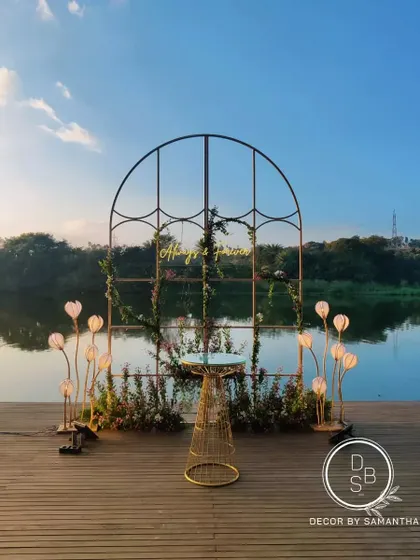 The reception backdrop set against the still waters of a natural lake at sunset. The changing colors of the sky created the most beautiful, evolving canvas for the "Always & Forever" sign.