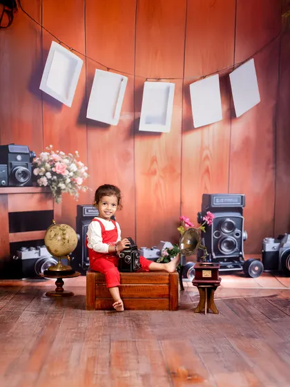 Tiny hands, vintage plans, and endless charm. The "Little Shutterbug" theme is perfect for a family of photographers, featuring vintage cameras and a rustic wood backdrop.