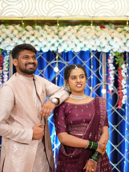 This photo shows the couple enjoying a lighthearted moment. The decorated stage in the background enhances the festive mood of the celebration.