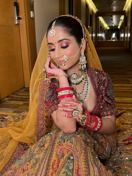 Bringing bridal dreams to life, one brushstroke at a time. This bride looks absolutely stunning in her unique, multi-colored lehenga with a yellow dupatta.