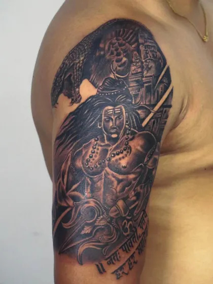 A powerful full-bicep tattoo of Lord Shiva in his warrior form. The background shows a temple and his loyal bull Nandi, creating a complete scene of divine power and devotion.