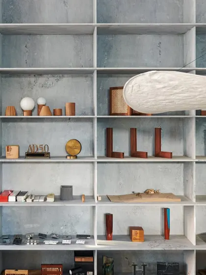 Our material library and model display, housed in a floor-to-ceiling grid of marble shelves. This library is a working tool and a source of inspiration, showcasing our commitment to detail, finesse, and simplicity.