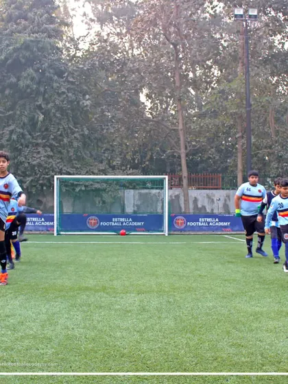Players engaged in dynamic warmups, including leg swings, to prepare for a session of drills and practice matches. This ensures they are ready for action from the first whistle.