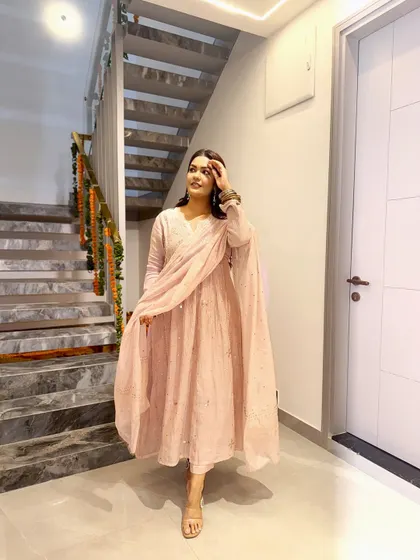 This pastel pink Anarkali with mirror work is perfect for a daytime event. The light fabric and soft color feel fresh and celebratory.