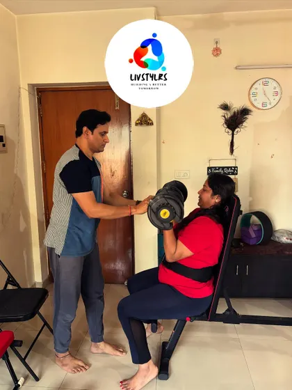 I am guiding a client through a seated bicep curl, focusing on controlled movement to build arm strength effectively.