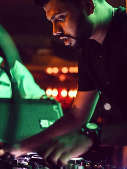 A candid moment captured mid-mix. This close-up shows the concentration it takes to blend tracks smoothly and keep the party going without missing a beat. This is the craft I love.