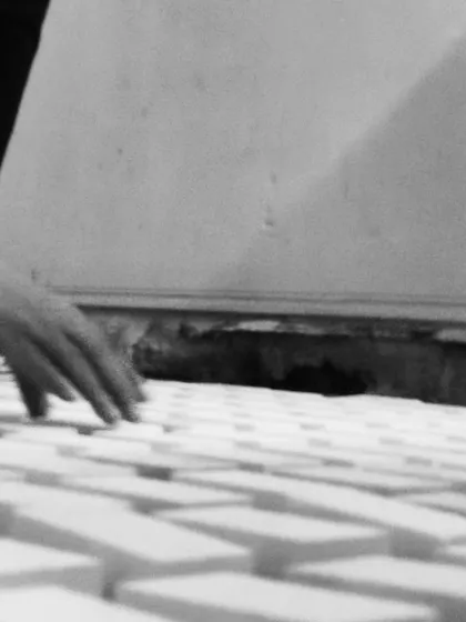 The tactile process of arranging individual tiles for a terrazzo floor design. We believe in feeling the materials and patterns with our own hands to ensure the result is perfect.