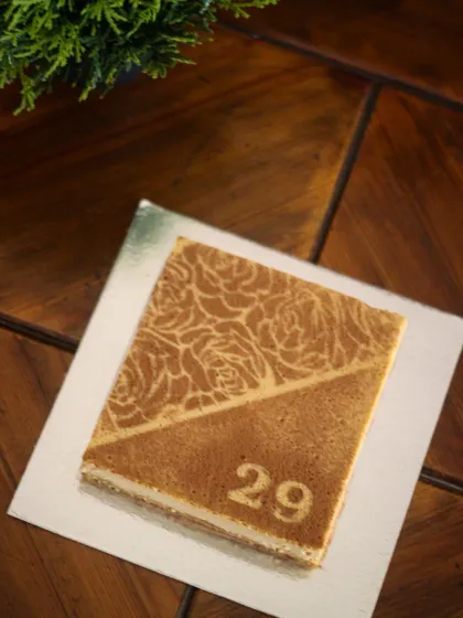 My bestseller, the boozy coffee cheesecake, decorated for a 29th wedding anniversary. The intricate rose stencil and custom number make it a sophisticated and delicious way to celebrate a milestone.