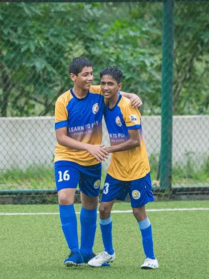 Two of our U15 players celebrating a moment together on the pitch during a league game.