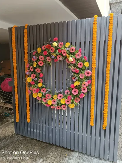 Even a simple gate can be made beautiful. For this entrance, I created a large wreath of fresh, colorful gerbera daisies and hung strings of marigolds for a traditional and welcoming look.