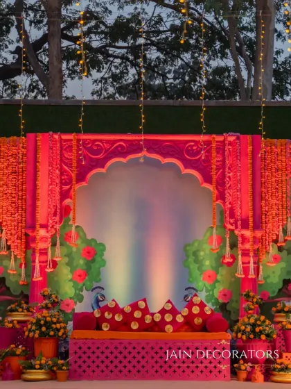 For a Haldi or Mehndi, I love to play with vibrant traditions. This stage is a burst of joyful color, combining fuchsia, marigold, and intricate Rajasthani-inspired architecture to create a festive and photo-perfect setting.