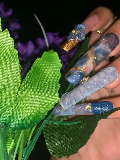 A detailed close-up of the marbling and textured effects on the nail extensions.