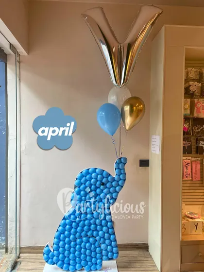 A cute baby elephant made from a mosaic of blue balloons, created for an April birthday celebration.