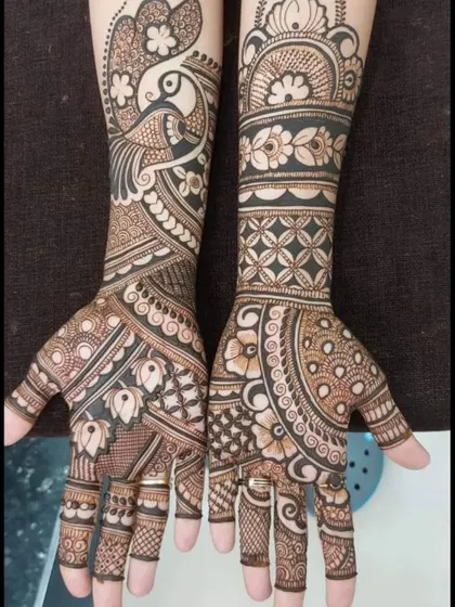 A mix-and-match design with a peacock on one hand and geometric patterns on the other. This shows the variety of styles I can create in a single session.
