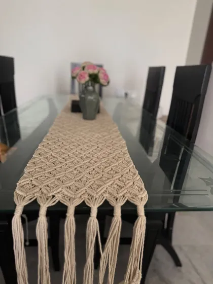 Our macrame-style table runner, adding a touch of texture and bohemian elegance to a modern glass dining table.