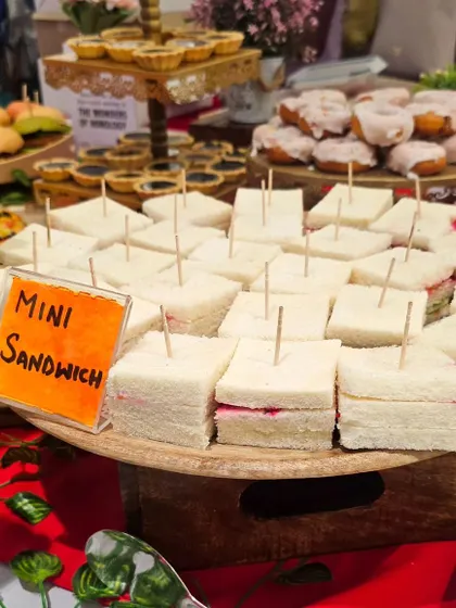A close-up of the mini sandwiches served at a hi-tea event. These rainbow sandwiches are as beautiful as they are delicious.