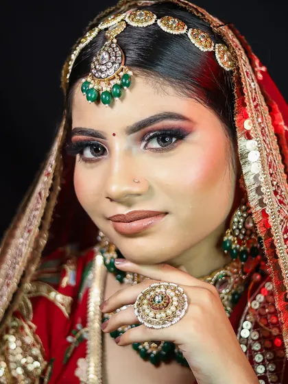 A close-up shot focusing on the stunning eye makeup and the large, traditional ring.