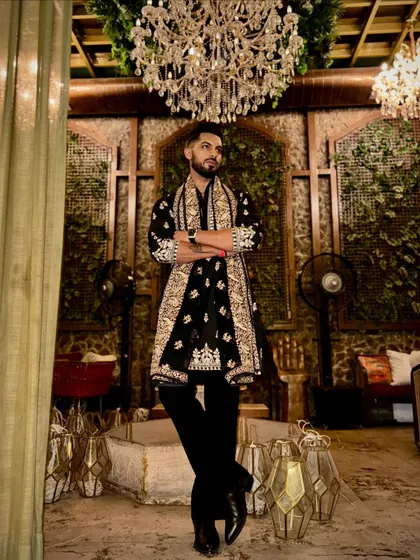 A confident stance in a grand setting. This outfit, with its intricate embroidery and luxurious feel, is designed to make you feel your best during any celebration.