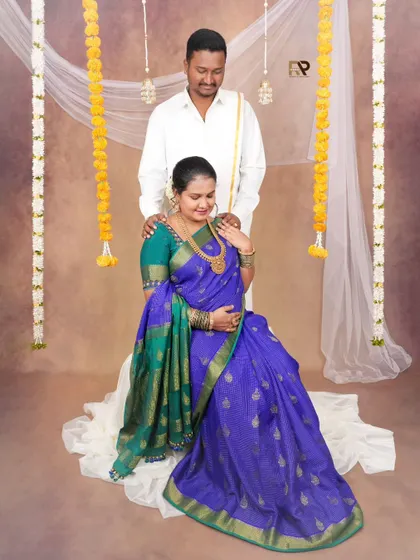 A loving couple's portrait. The dad-to-be stands behind his partner, his hands gently placed on her shoulders, showing support and affection.