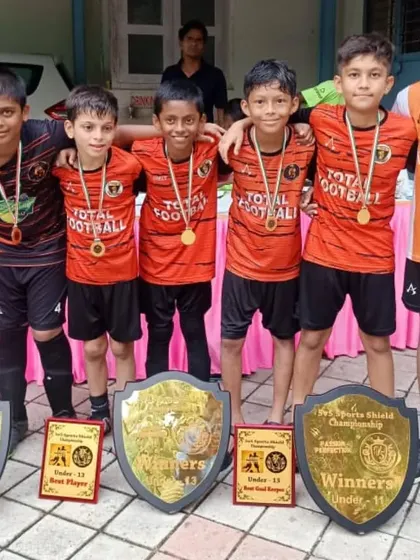 The U13 champions posing with their trophies and awards at the 5v5 Sports tournament.