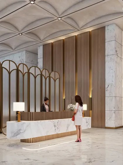 The reception desk in our South Mumbai project, crafted from a single piece of marble. The space is defined by a vaulted ceiling, brass accents, and a mix of modern and classic design elements, marrying exquisite detail with functionality.