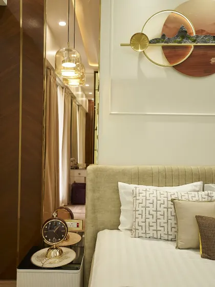 The reflection in the mirrored wardrobe panel shows a glimpse of the dressing area, a clever way to make the room feel larger and more connected.