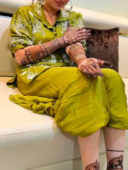 A relaxed moment with a client showcasing her elegant mehandi design.