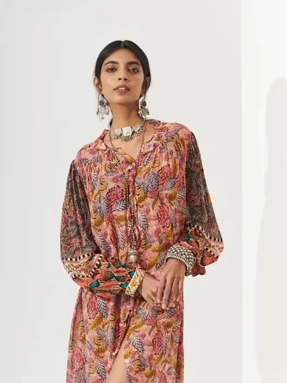 A polished makeup look for Shopverb, paired with bold silver jewelry. The makeup is clean and defined, balancing the detailed print of the dress and the statement accessories.