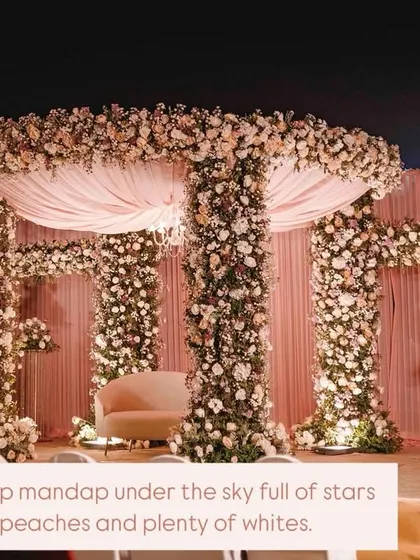 For Sakshi and Shuvam's wedding, we created this opulent mandap under the stars. The structure was completely covered in lush pink, peach, and white florals, with a soft fabric canopy and a chandelier for a touch of timeless elegance.
