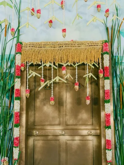 The details of the doorway decor, featuring thoran made from palm leaves and delicate floral accents, showcasing our commitment to craftsmanship.