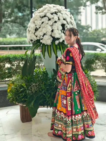 The full Garba look! The colorful outfit and the fun hairstyle are a perfect match.