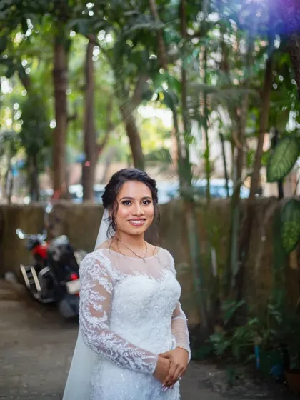 A classic bridal portrait. Her elegant updo and flawless makeup create a look of timeless sophistication.
