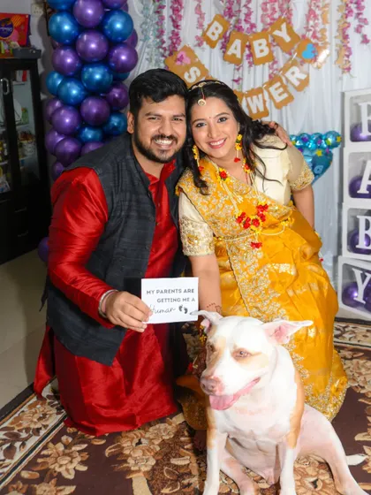 Even pets are part of the family! A fun and unique baby shower photo including the couple's dog with a cute sign.