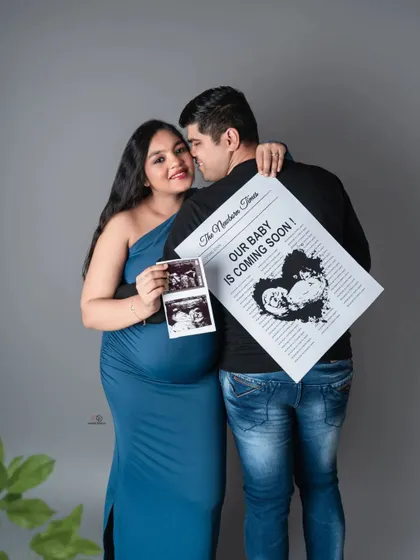 A fun and creative way to announce your exciting news together. This couple's portrait with a custom newspaper and ultrasound photo is a keepsake you'll cherish forever.