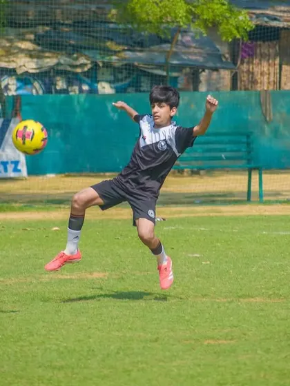 An acrobatic volley attempt, capturing the creativity and flair that makes youth football so exciting to watch.