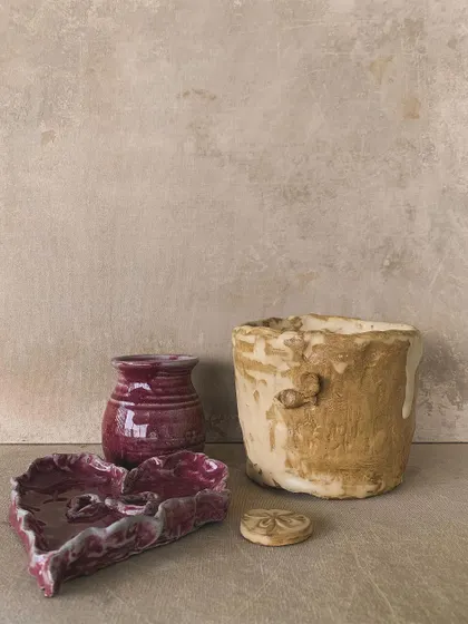 A closer look at some of the imperfectly beautiful pieces, including a heart-shaped dish and a textured pot.