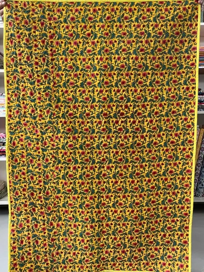 The back of the bright Bargello quilt, featuring a cheerful yellow floral fabric.