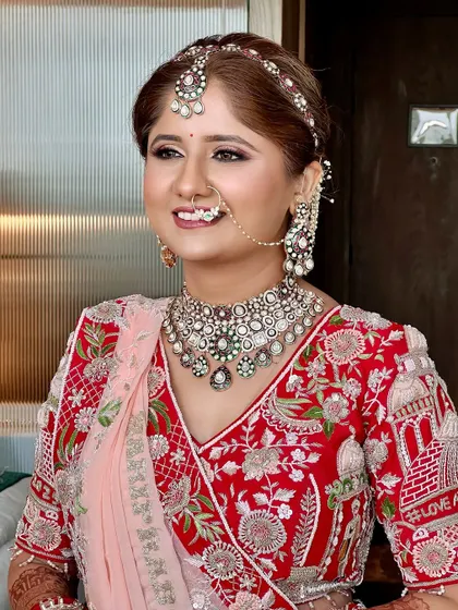 A candid shot of the bride, her smile radiating happiness. The makeup is designed to look perfect in every light.