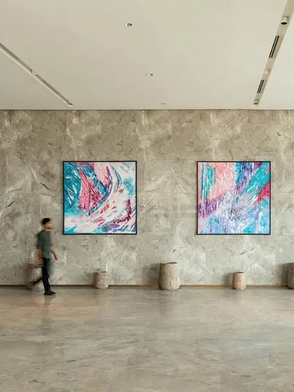 The lobby of the One Golden Mile office building is conceived as a calming transition space. We used a palette of natural stone and displayed large-scale contemporary art to create an atmosphere that puts people at ease, offering a contrast to the chaos of the city.